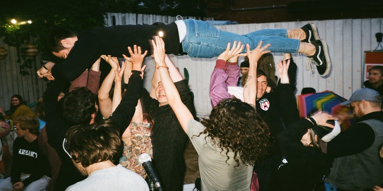 Canva - People Lifting Man at Night